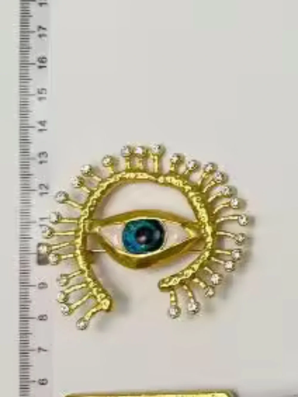 Gold-Tone Brooch with Blue Eye and Crystal Accents
